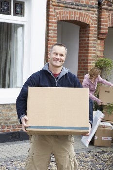 Professional movers handling office equipment